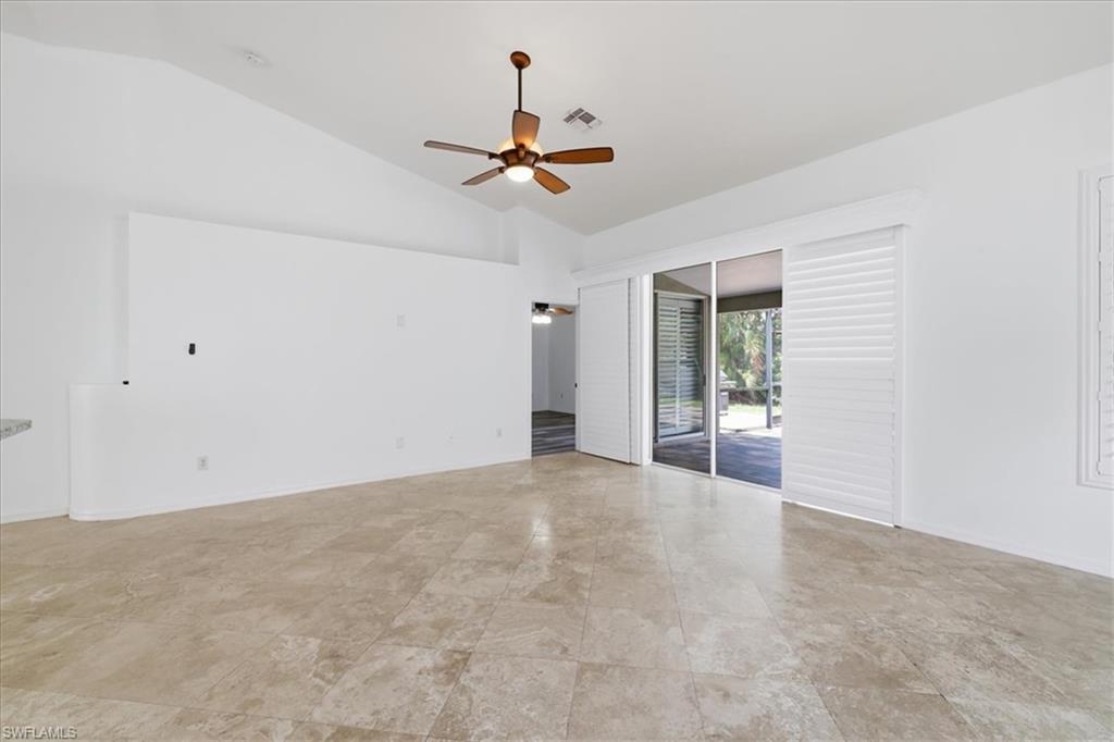 Spacious interior featuring vaulted ceilings and large format tile flooring