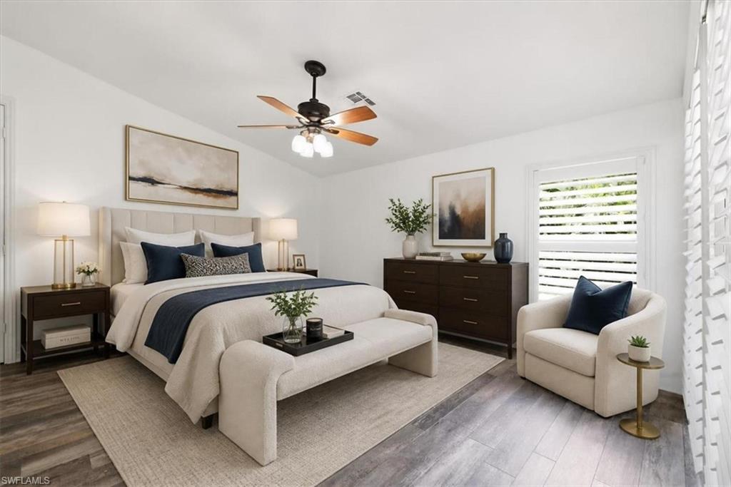 Vaulted ceiling with a ceiling fan, wood-finish flooring, white plantation shutters, and recessed lighting