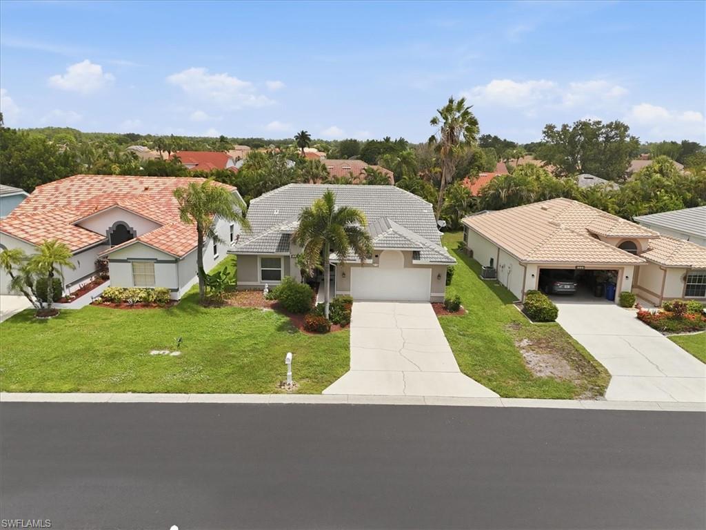 Single-story residence featuring a gray tile roof and attached garage
