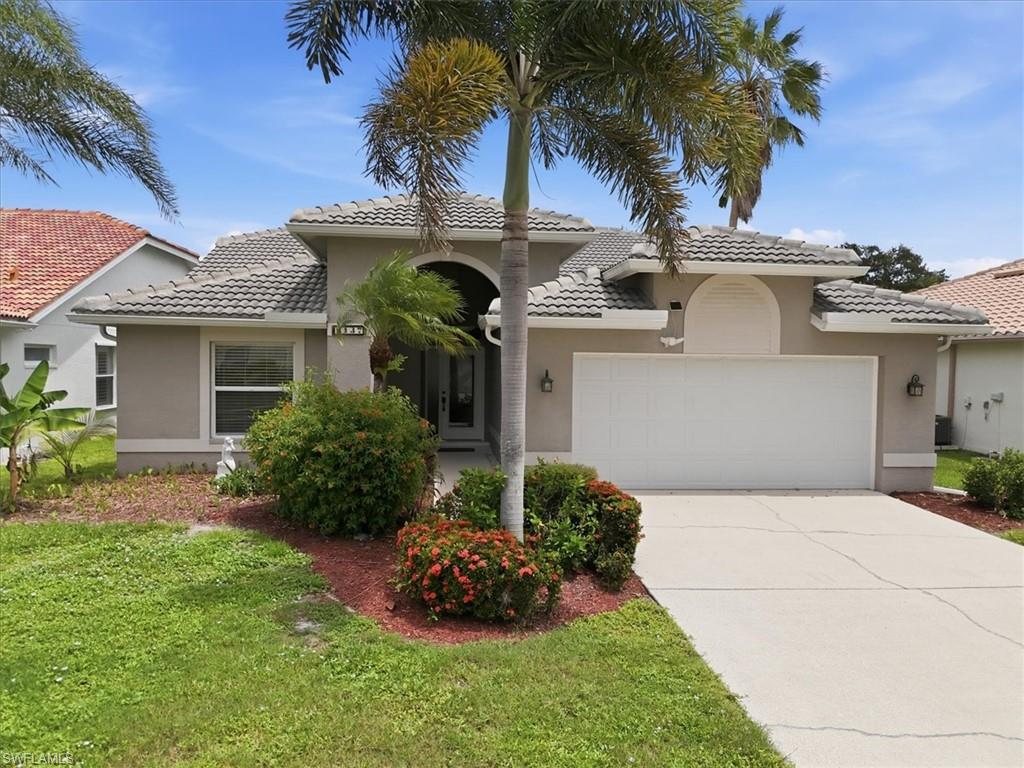 Contemporary single-story exterior featuring a tile roof, stucco facade, and an integrated two-car garage