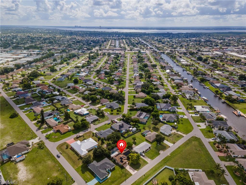 Aerial view showcasing a residential neighborhood with a prominent canal system