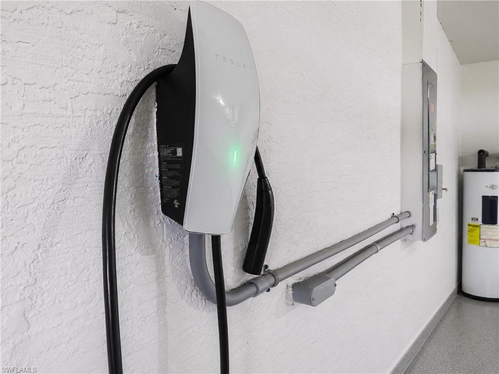 Wall-mounted electric vehicle charging station with integrated cabling