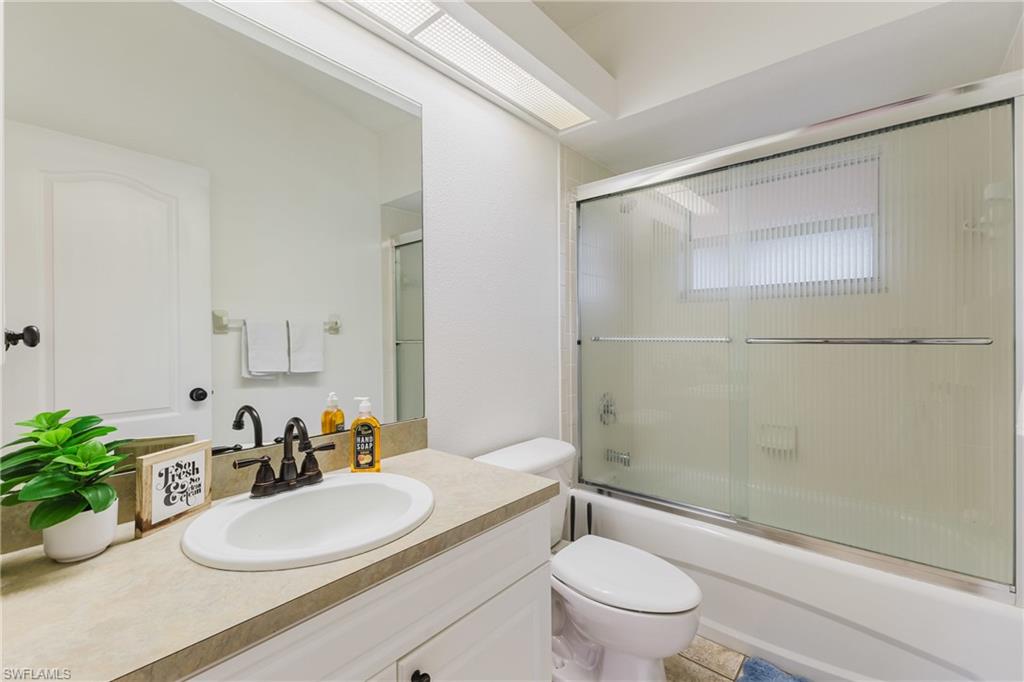 Bathroom featuring a single vanity with an integrated sink, bronze-finish faucet, and substantial mirror