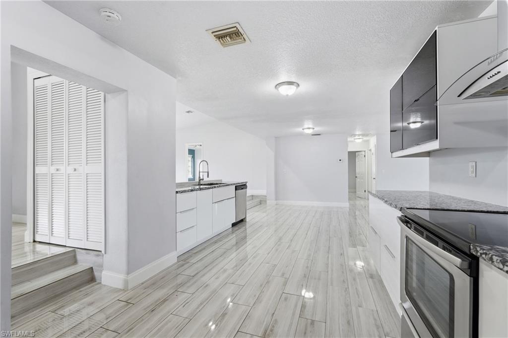 Hall way to the left leads to storage closet, full bathroom, indoor laundry room and access to the Lanai.  Add a pool and you would quick access to the bathroom.