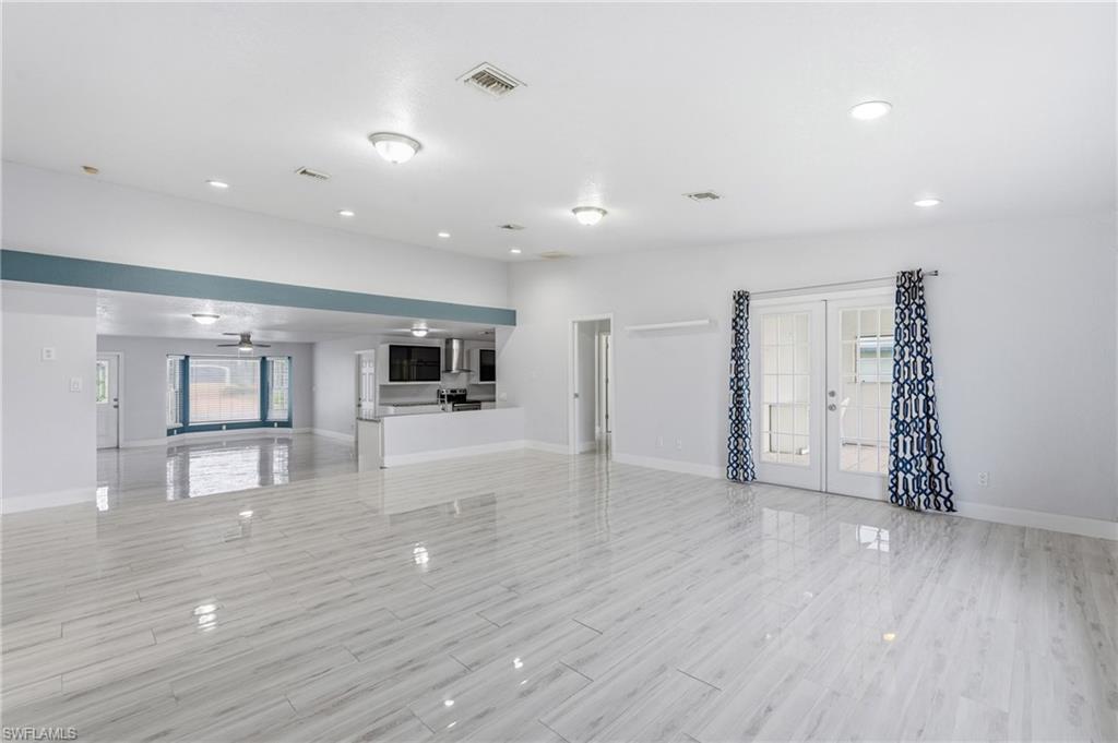 Open concept living looking toward the kitchen and bonus space.