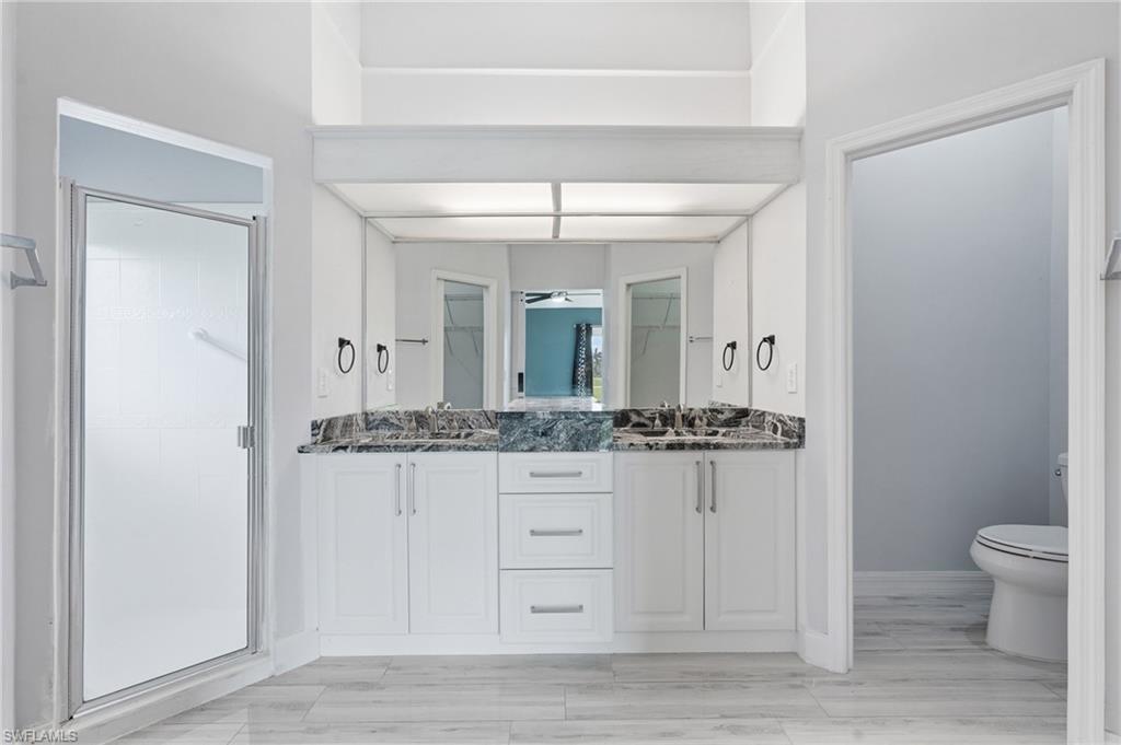 Updated bathroom cabinets, granite double bowl sinks and commode.  Tile Continues through the home.