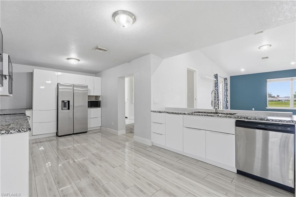 Modern remodeled Kitchen, Granite Counter Tops, Stainless Steel Appliance, Vented Hood fan