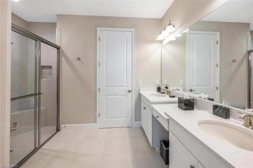 Dual vanity with light-toned countertops and undermount sinks