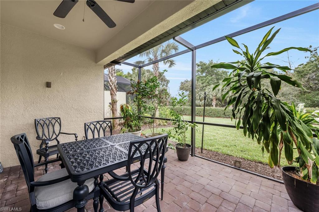 Screened patio featuring a ceiling fan, recessed lighting, and a textured exterior wall