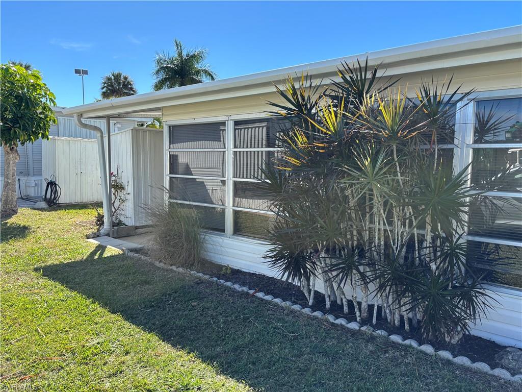 View of side of property with a yard