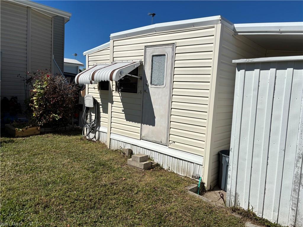 View of property exterior with a lawn