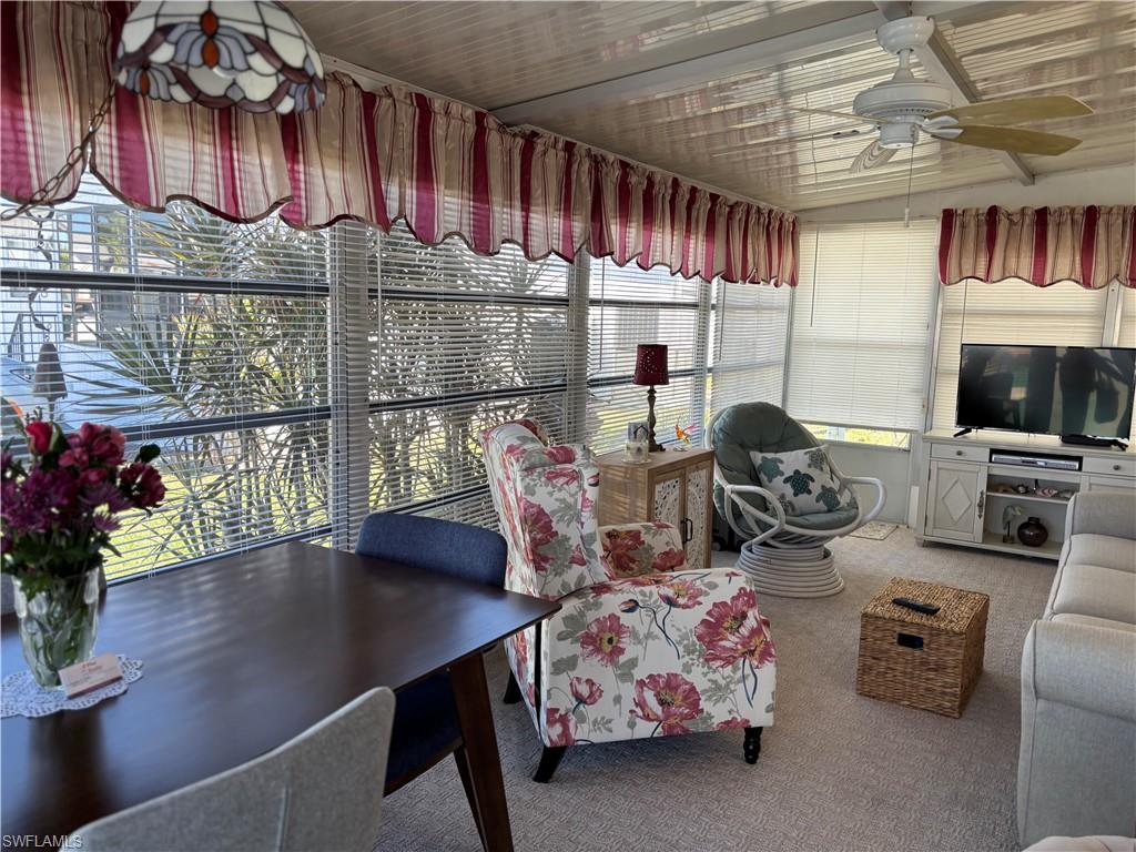 Sunroom / solarium featuring carpet floors and healthy amount of natural light