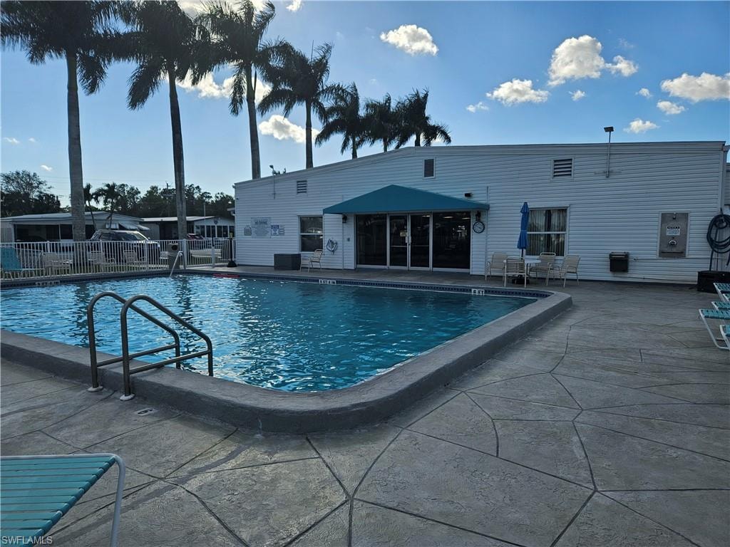 Community pool featuring a patio