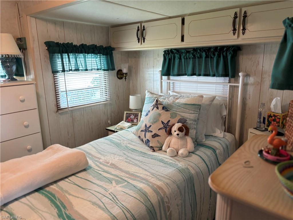 Bedroom featuring wood walls