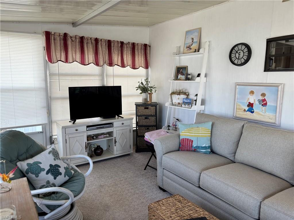 Living area featuring light carpet