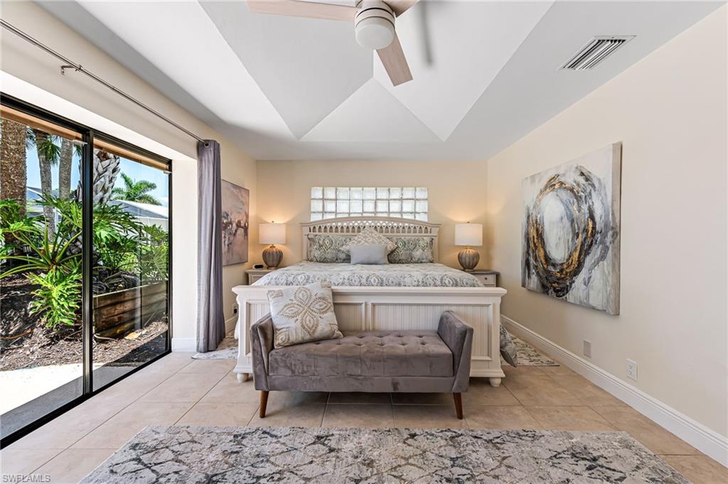 Bedroom with access to outside, light tile patterned floors, and ceiling fan