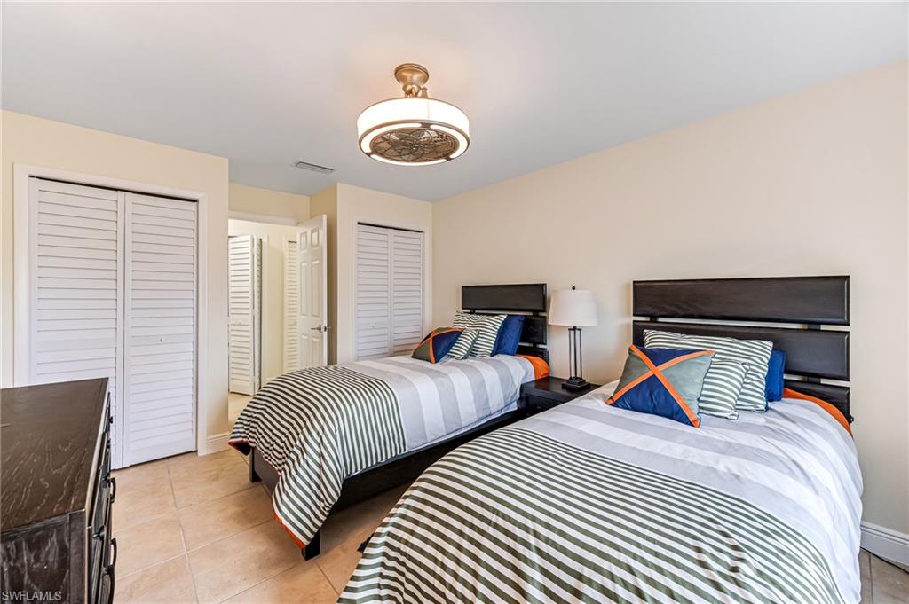 Twin bedroom with multiple closets