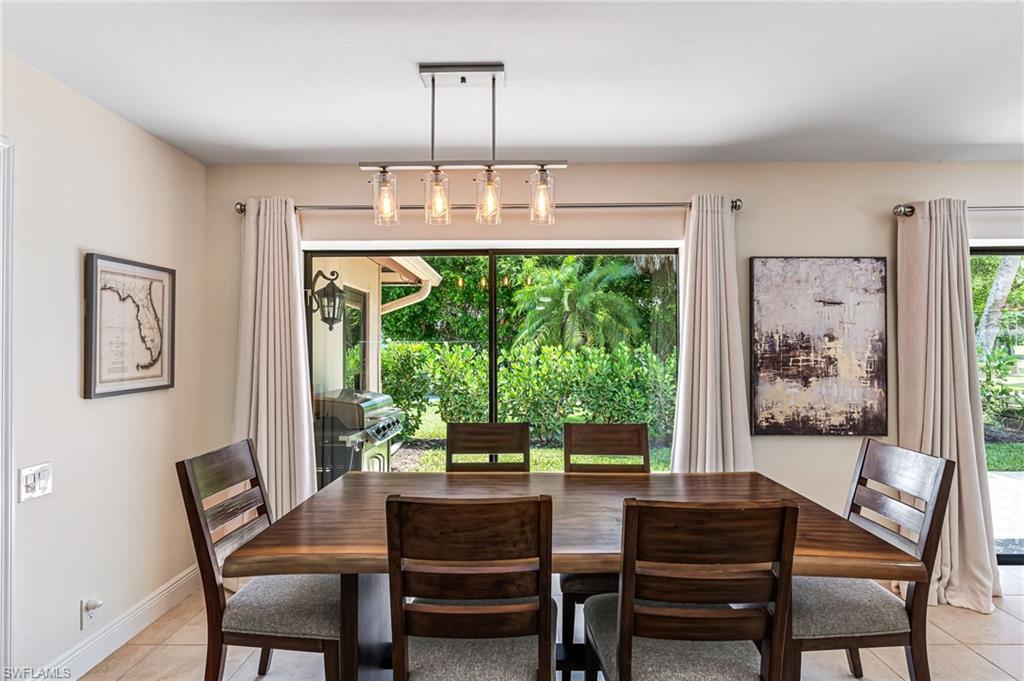 Dining space with light tile patterned flooring