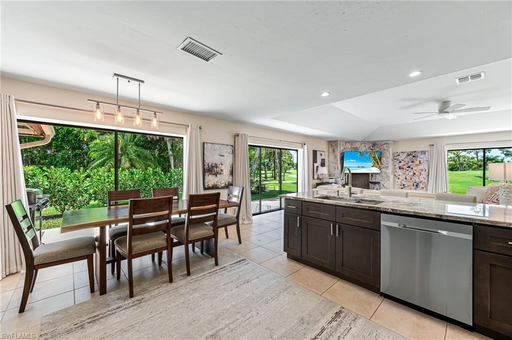 Kitchen featuring dishwasher, a healthy amount of sunlight, light stone countertops, and ceiling fan