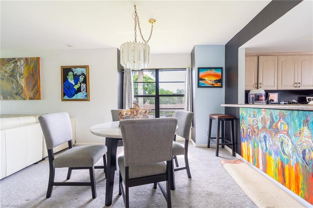 Dining area featuring a contemporary chandelier, a round table, and upholstered dining chairs