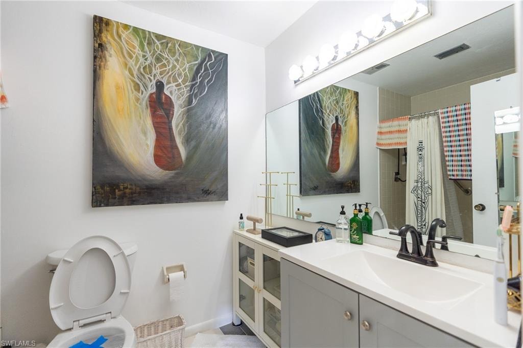 Bathroom vanity with a white countertop and undermount sink, complemented by a matte black faucet