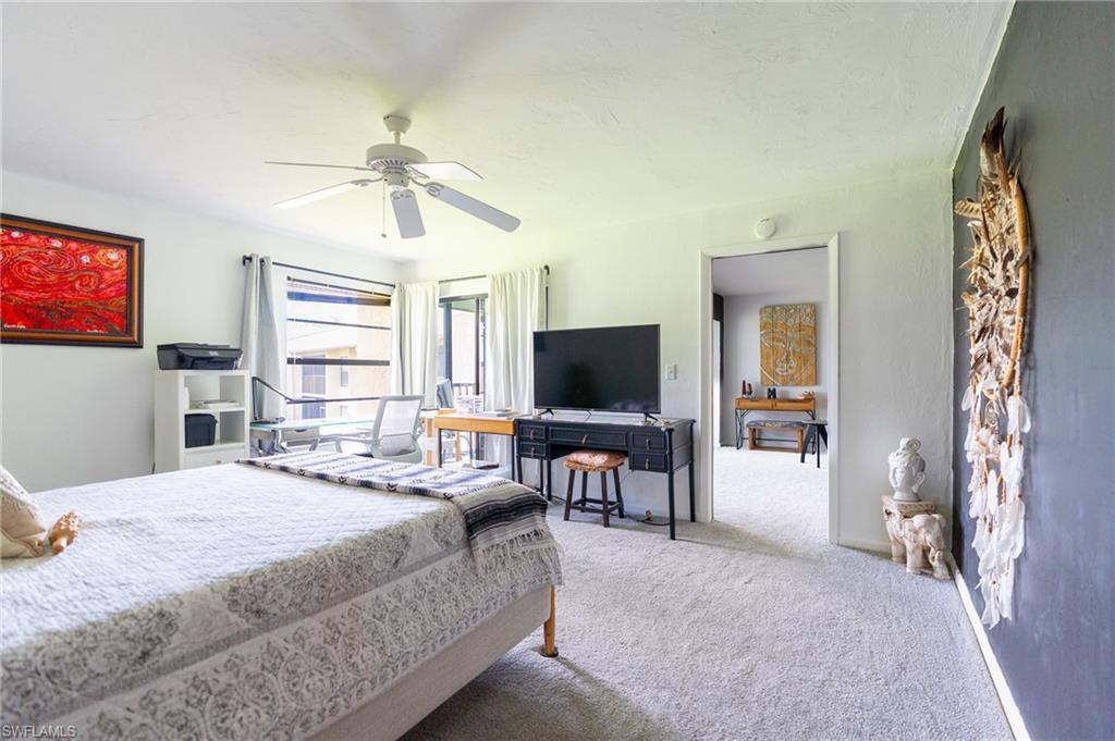 Spacious room featuring light-colored carpeting and a ceiling fan with light fixture