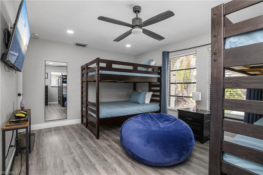Spacious room featuring wood-finish flooring and light gray walls