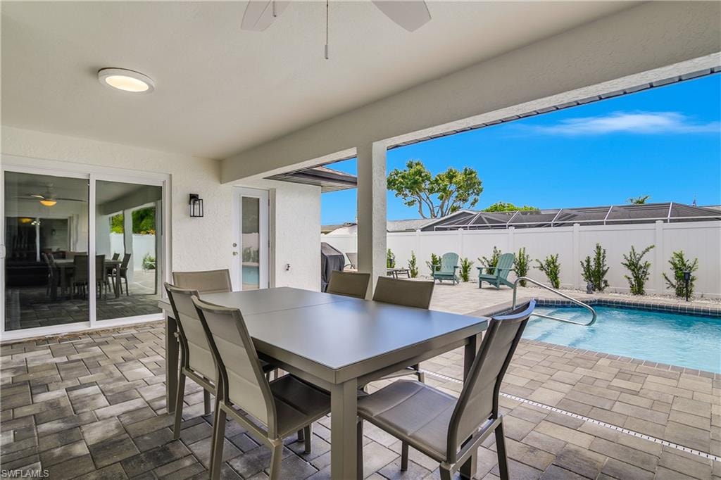 Covered patio featuring an outdoor ceiling fan and recessed lighting