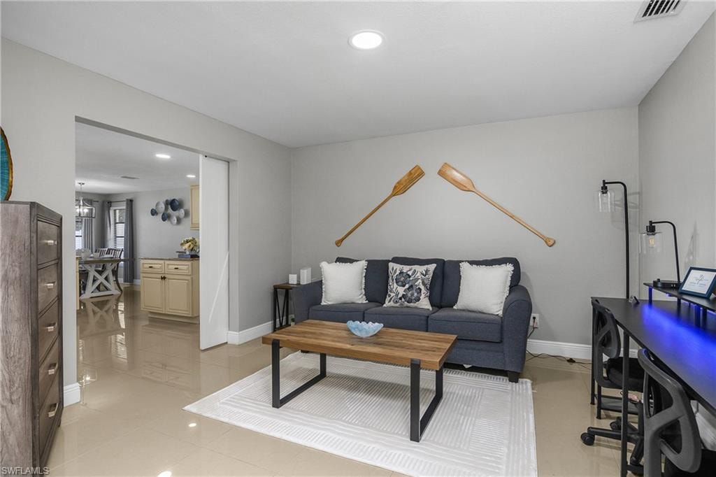 Spacious interior featuring neutral wall tones and light-toned tile flooring