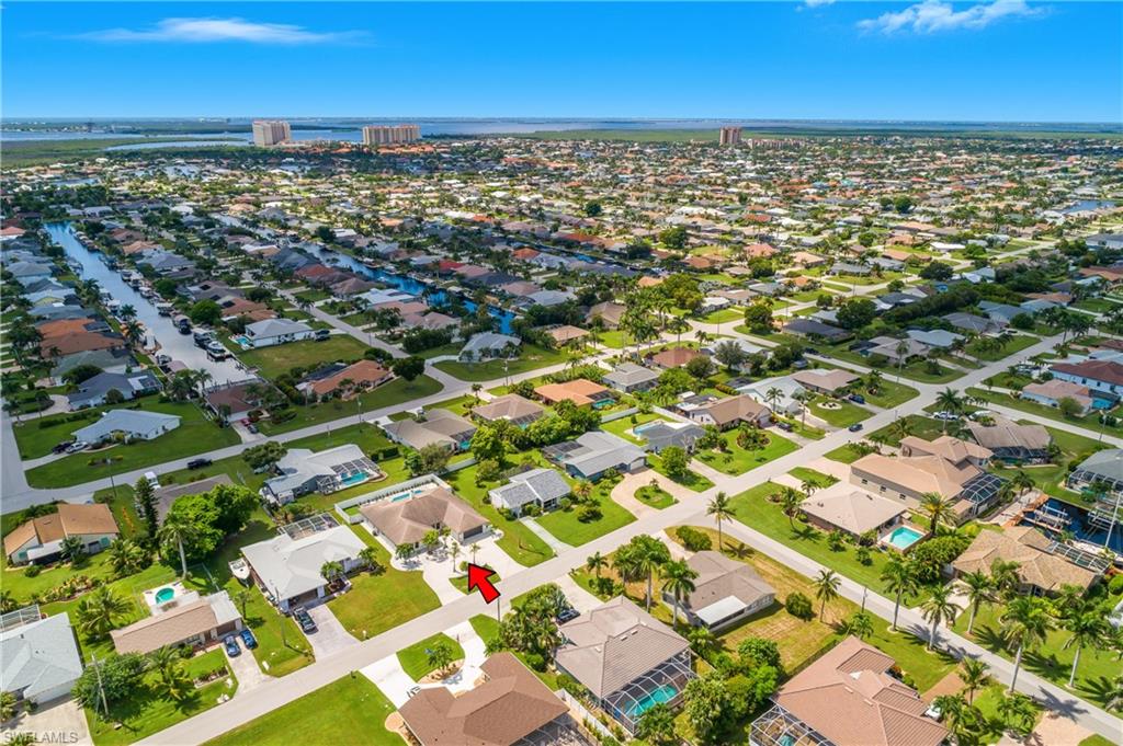 Aerial perspective showcasing a residential neighborhood with numerous single-story properties