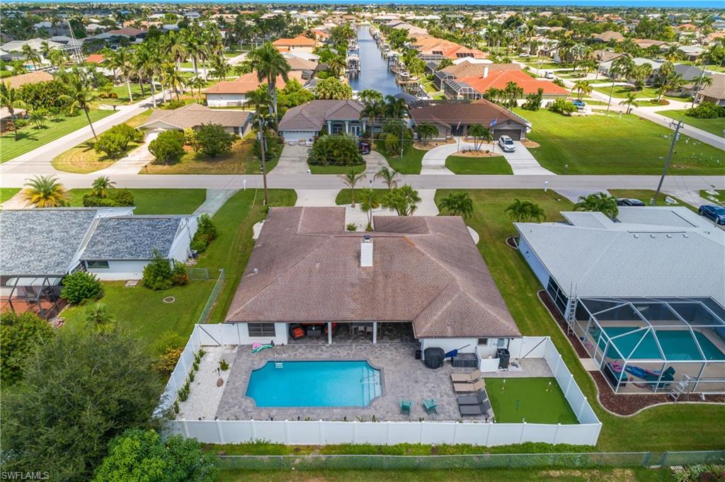 Residential property with an in-ground pool, paver patio, and fenced backyard