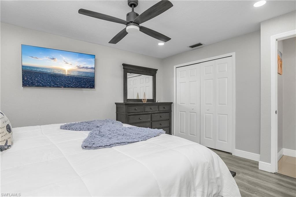 Neutral gray walls with recessed lighting and a ceiling fan