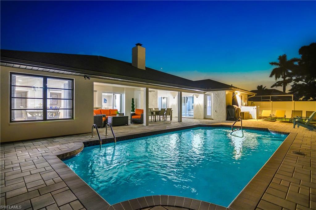 Rectangular swimming pool with integrated steps and a surrounding paver patio