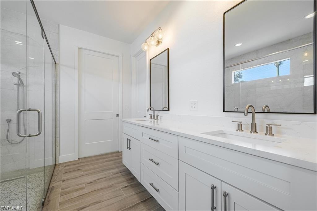 Bathroom featuring vanity and an enclosed shower