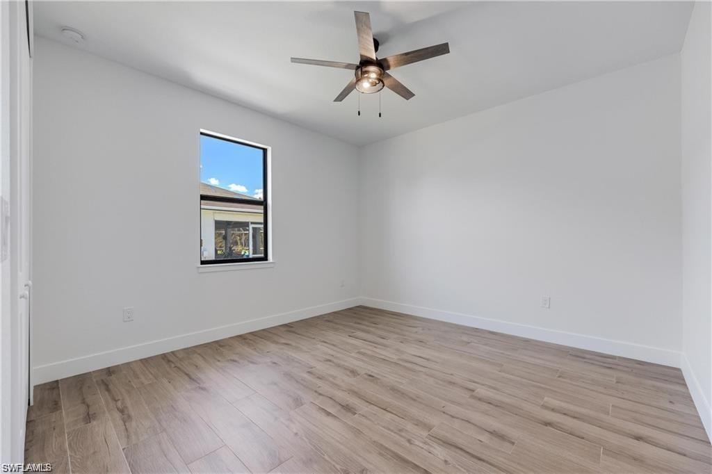 Unfurnished room with ceiling fan and light hardwood / wood-style flooring
