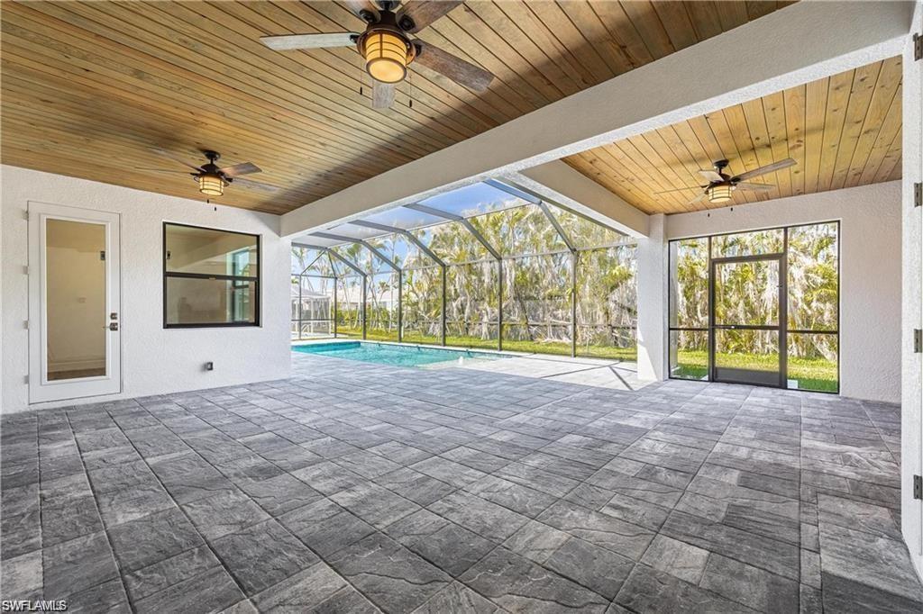 View of patio featuring ceiling fan and glass enclosure