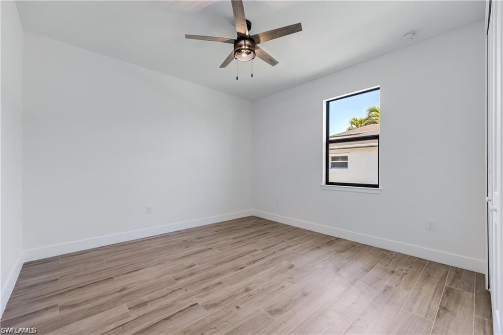 Unfurnished room featuring ceiling fan and light wood-type flooring