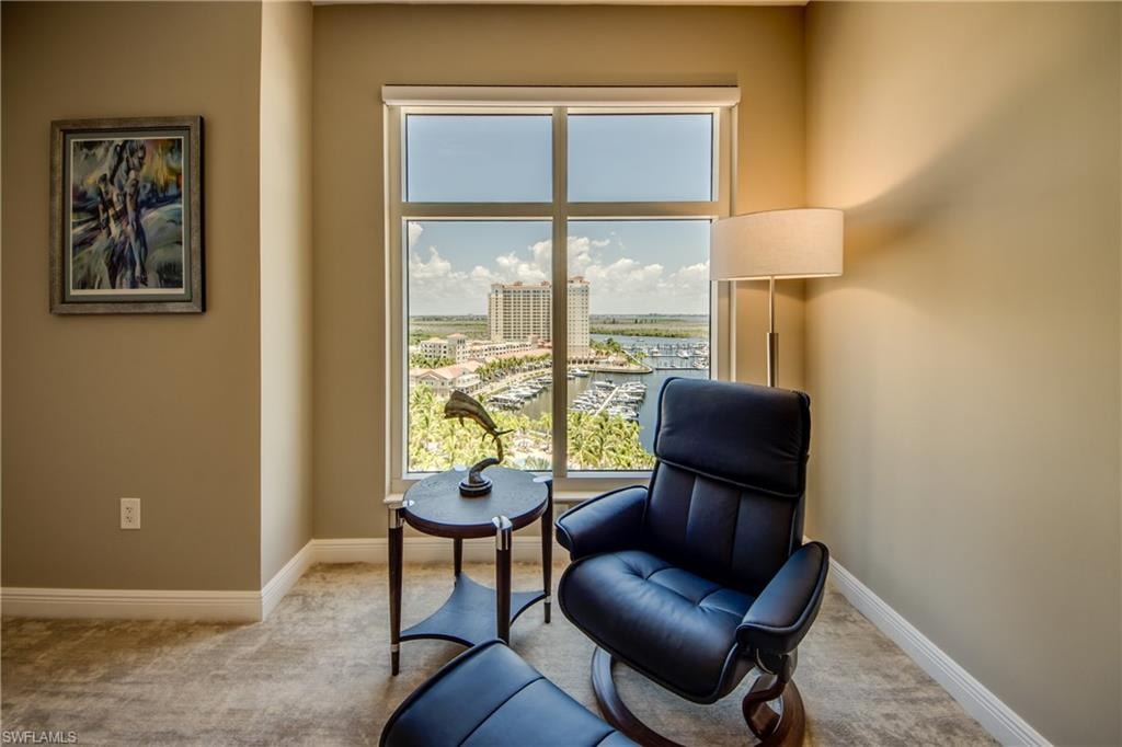Floor-to-ceiling window framing a marina