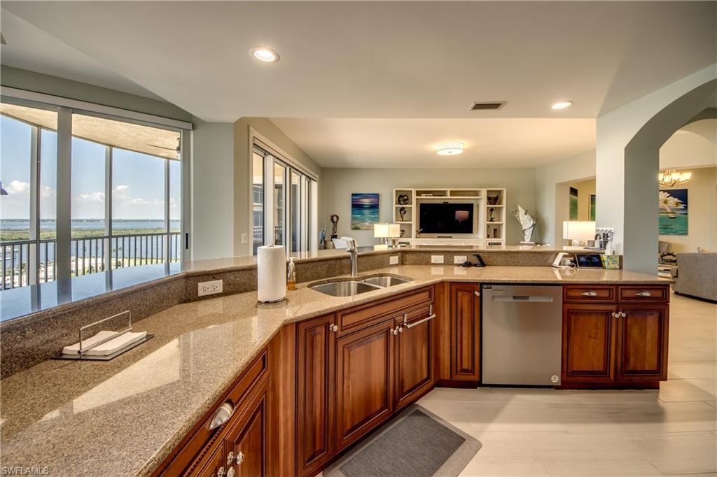 Spacious kitchen featuring wood cabinetry, granite countertops, and stainless steel appliances