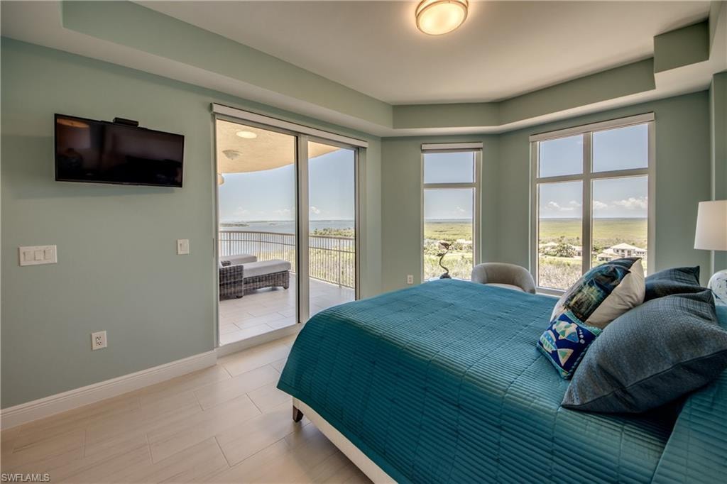 Bedroom featuring expansive windows