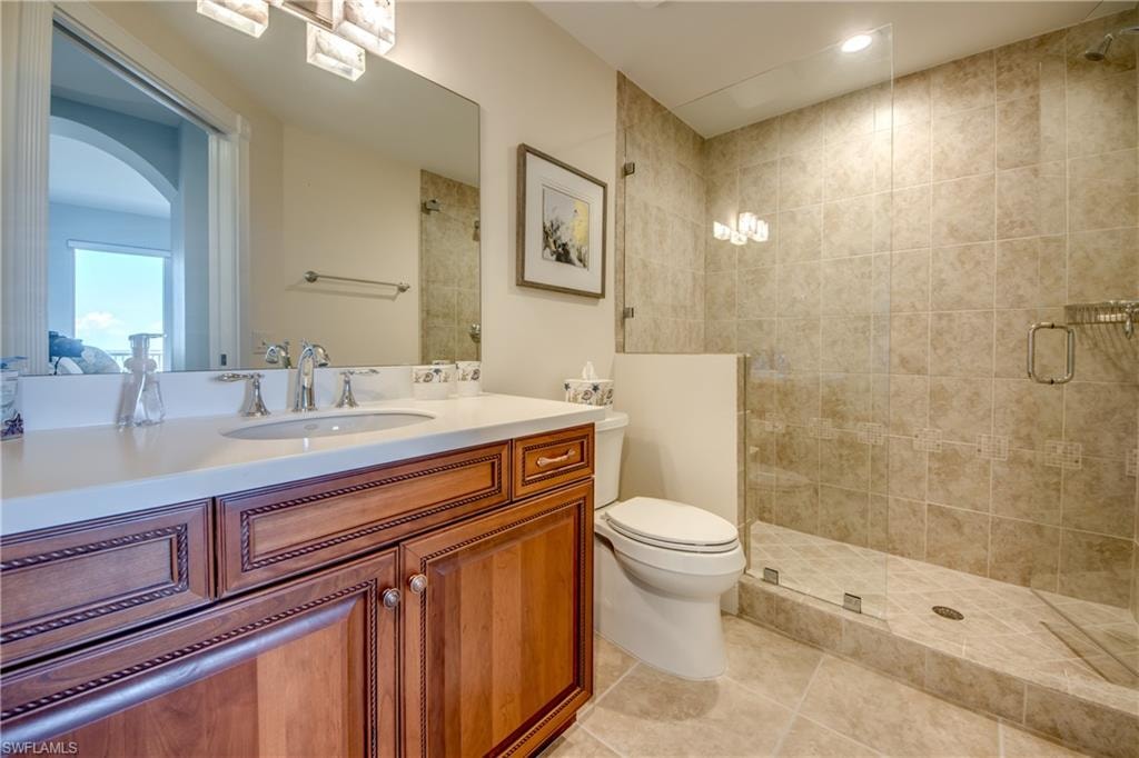 Tile-surround walk-in shower with glass enclosure