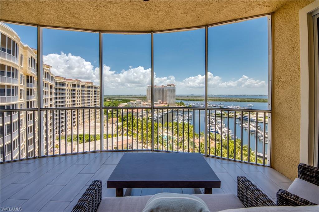 Expansive screened balcony featuring tile flooring and a textured ceiling