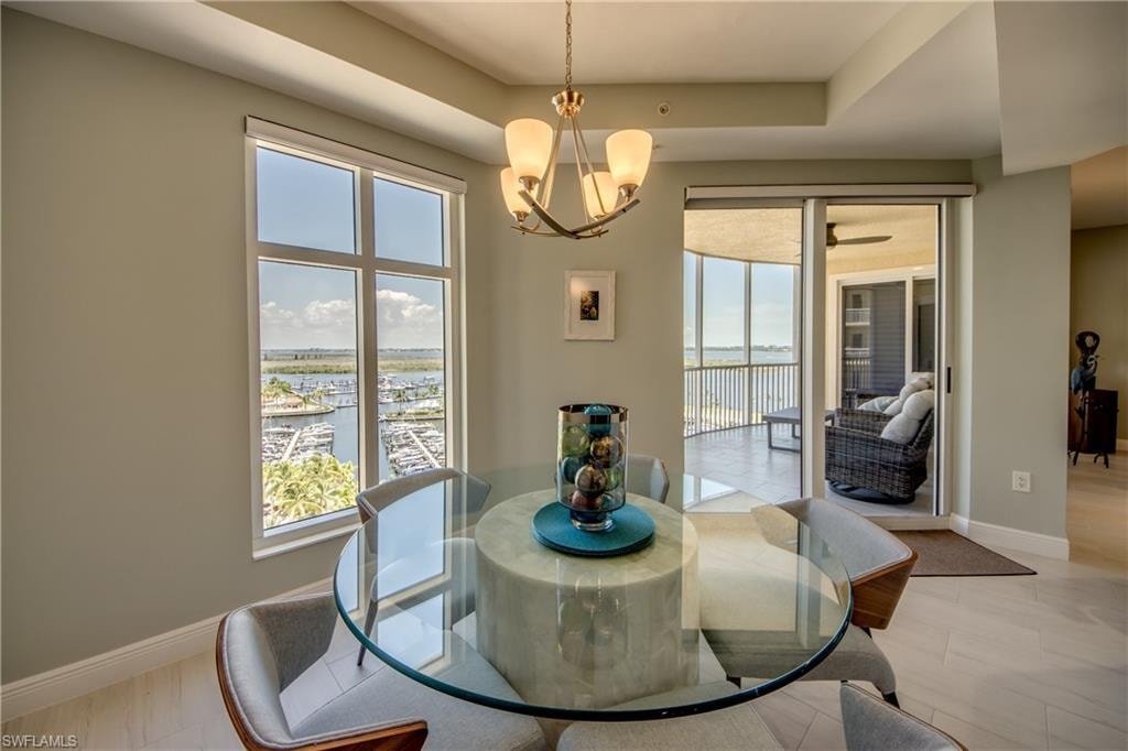 Dining area featuring a contemporary chandelier and large windows