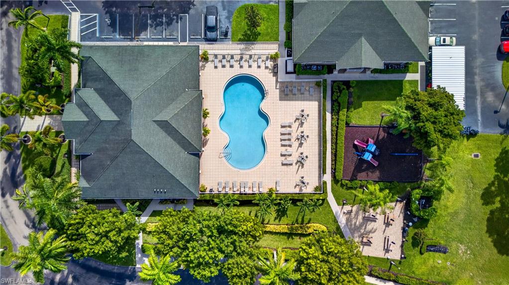 Resort-style pool area featuring a freeform swimming pool, surrounding patio, and multiple lounge chairs