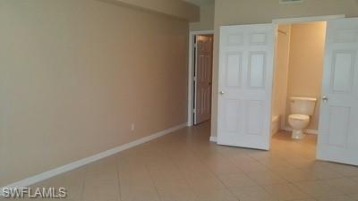 Neutral-toned walls complement the tile flooring
