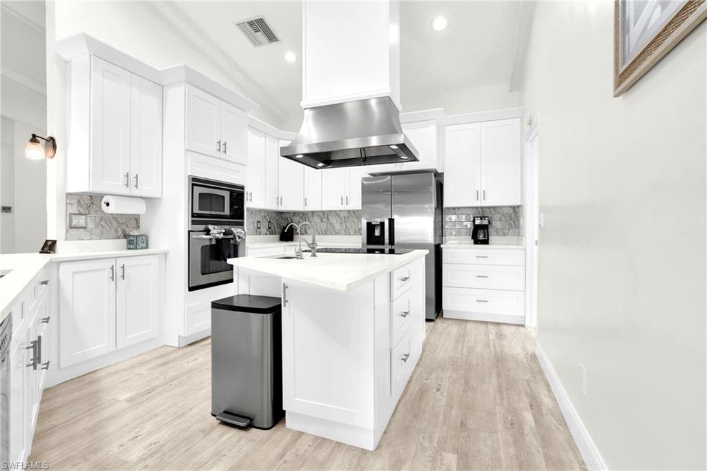 The Fully Equipped Island Kitchen Comes With Upgraded White Wood Cabinets & Drawers, Quartz Countertops, Tile Backsplash, Stainless Steel Appliance With Stainless Steel Hood, Wall Oven, Microwave, Stainless Steel Sink, Bosch Instant Under The Sink Hot Water Heaters, And A Multi-Person Breakfast Bar!