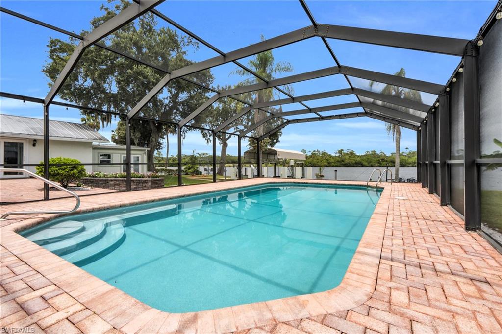 The Pool Area Come With A Paver Pool Deck And A Screened Lanai That Contains A Picture Window View At The End For A Maximum View Of The Amazing Caloosahatchee River!