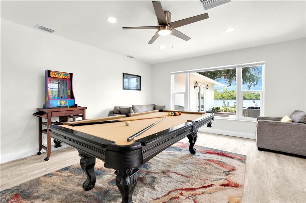 The Family Room/Game Room Has A Stone Walled Fireplace, Triple Hurricane Slider That Leads Out To The Covered Lanai/Pool Area, And A Large Picture Window With An Amazing View Of The River!