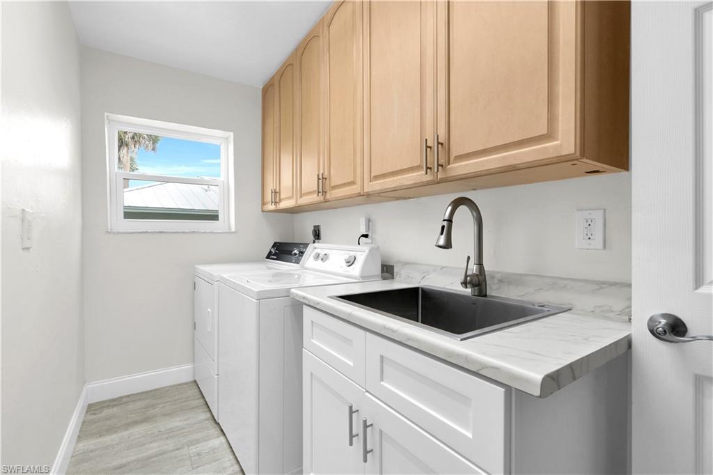 The Landry Room (One Of Two Landry Rooms) In This Home Is Equipped With A Washer & Dryer, Brand New Stainless Steel Sink, And Wooden Storage Cabinets!