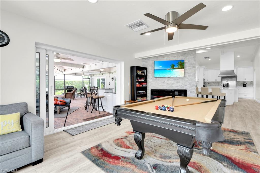 The Family Room/Game Room Has A Stone Walled Fireplace, Triple Hurricane Slider That Leads Out To The Covered Lanai/Pool Area, And A Large Picture Window With An Amazing View Of The River!